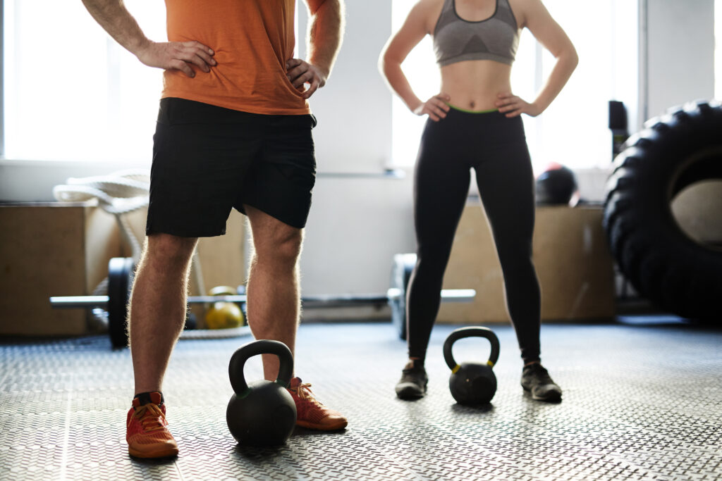 Couple working out with kettlebells