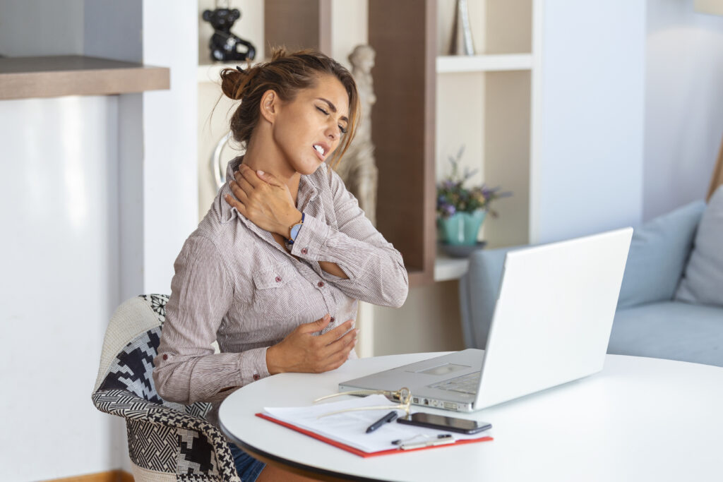Office worker massaging painful neck
