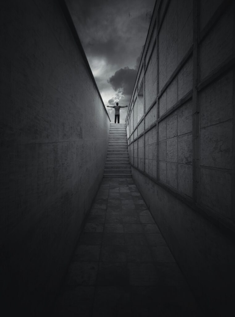 Person celebrating at the top of a staircase